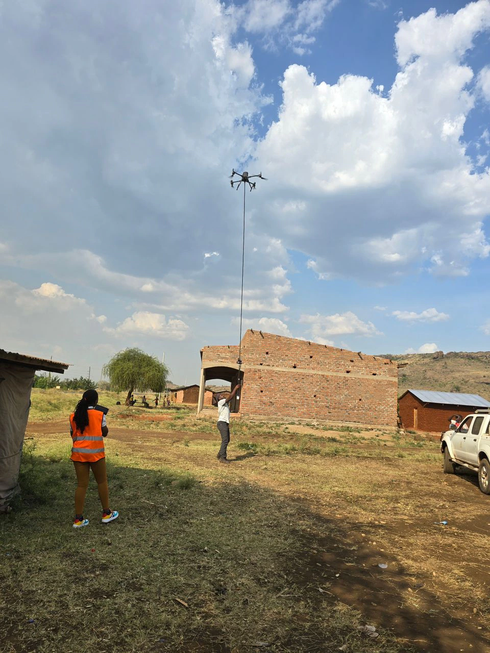 Drone carrying a suspended magnetic sensor in flight in the Elgon Mountain ranges, Kween